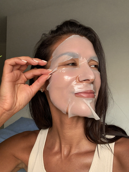 Woman peeling off the jelly mask revealing dewy glowing skin